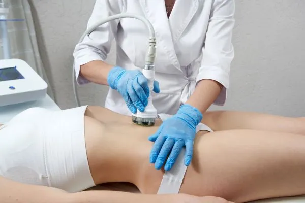Lost the Weight but Not the Loose Skin? 2 woman having HIFU treatment on her stomach to combat loose skin Braunstone Frith following weight loss